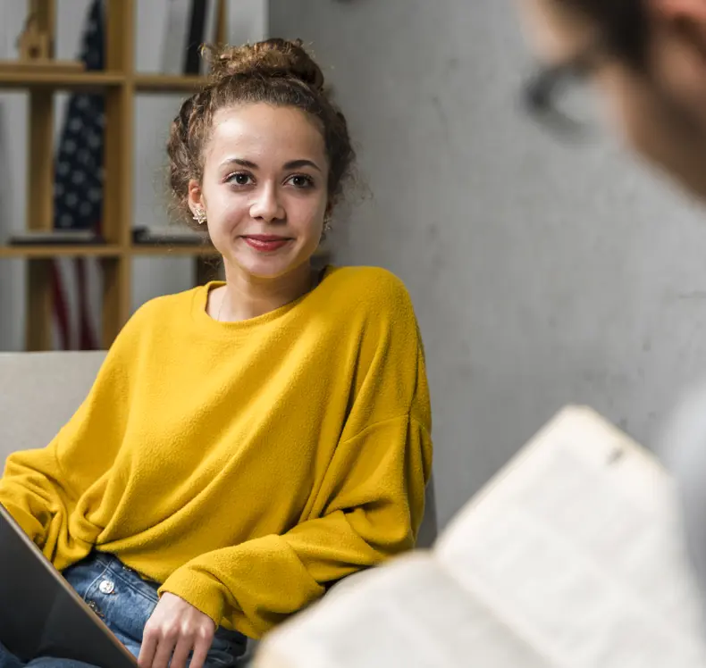 Close Up Students With Book Tablet Indoors (1)
